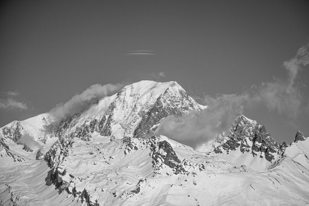 a black and white photo of a snow covered mountain