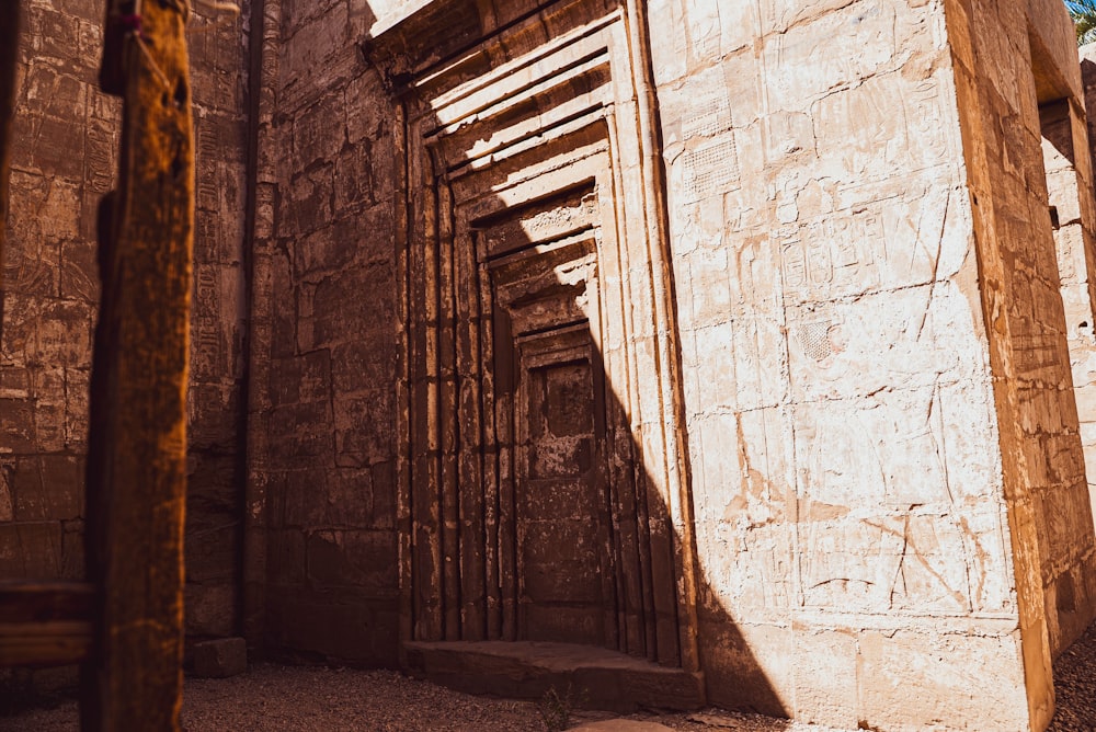 a stone building with wooden slats on the side of it