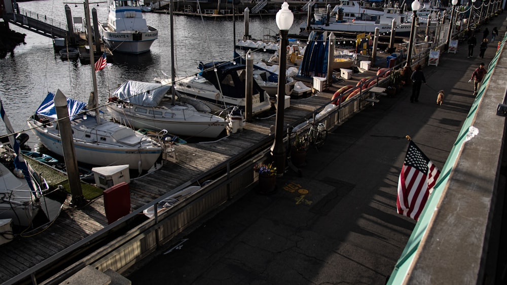 a marina filled with lots of boats next to a pier