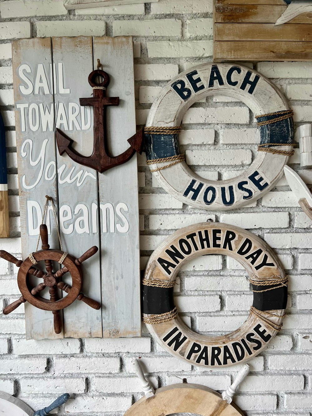 a white brick wall with various signs on it