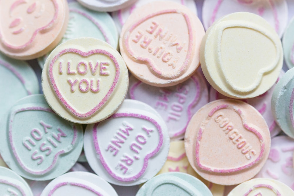 a pile of conversation hearts with i love you written on them