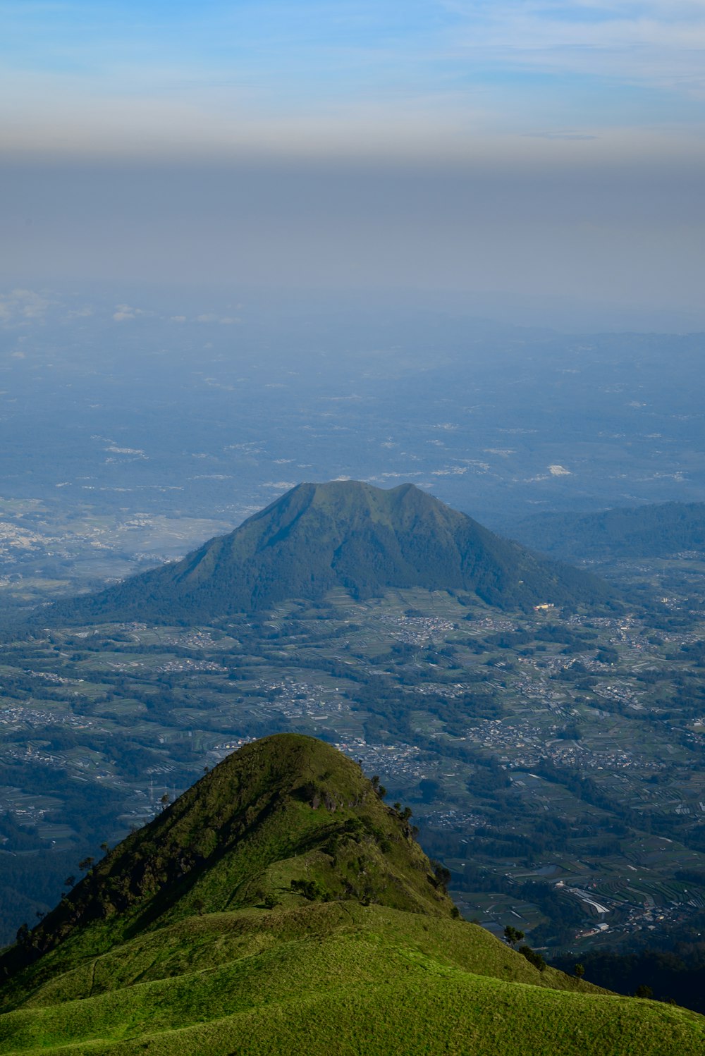 a view of a mountain with a blue sky in the background