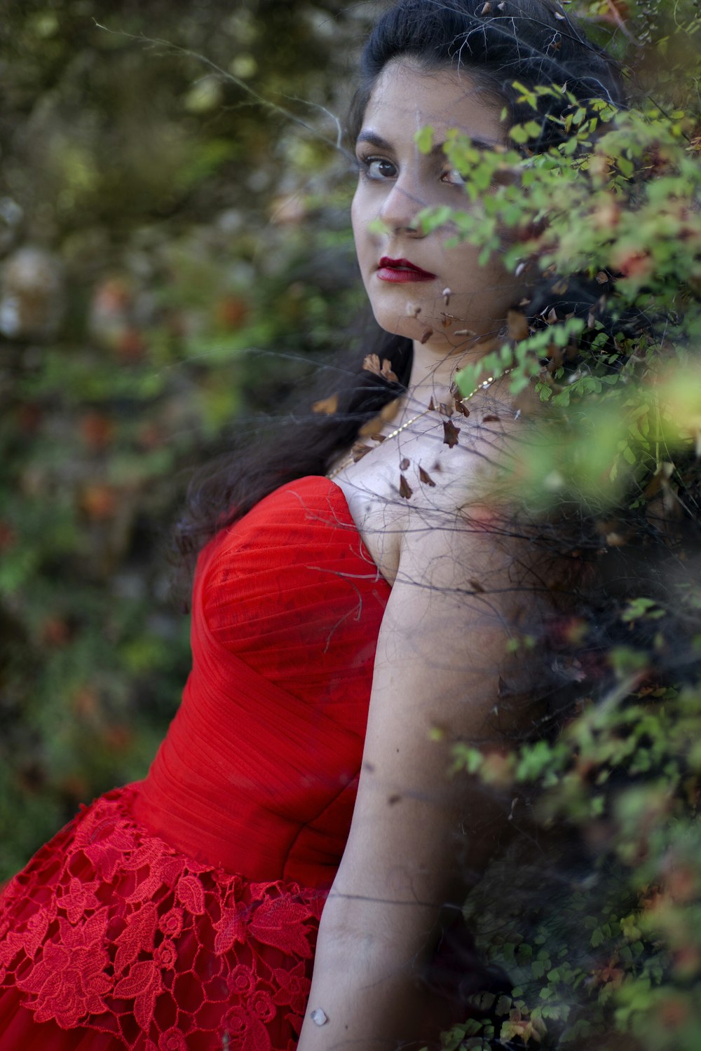 a woman in a red dress is posing for a picture