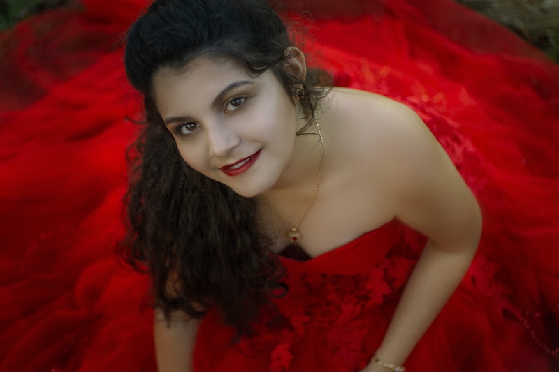 a woman in a red dress posing for a picture