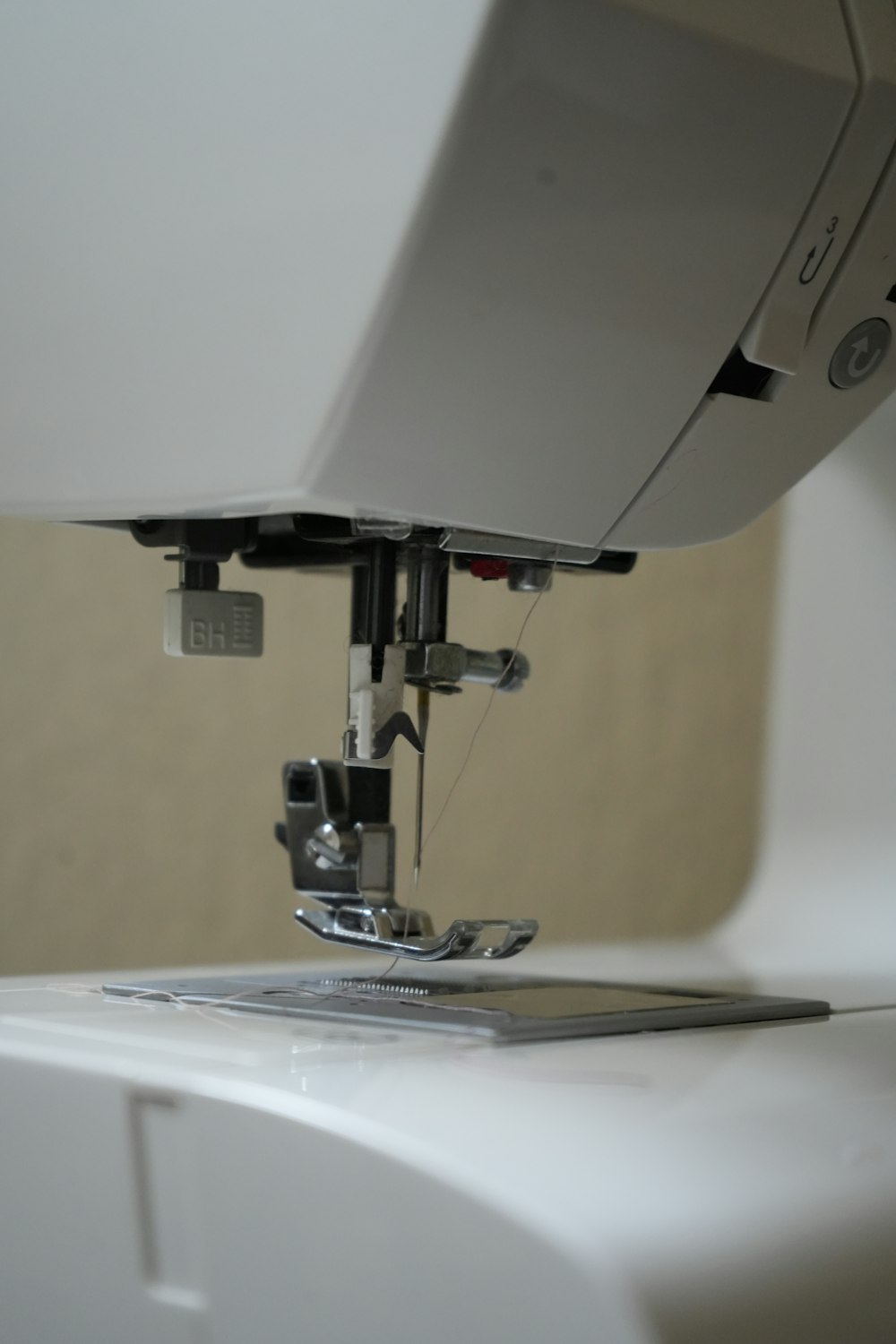 a close up of a sewing machine with a tablet on it