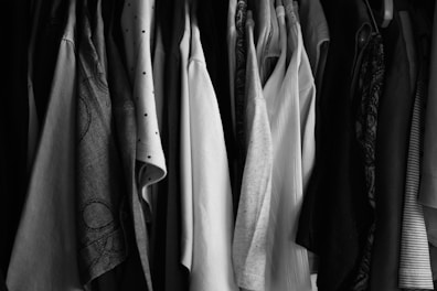 a bunch of clothes hanging on a rack