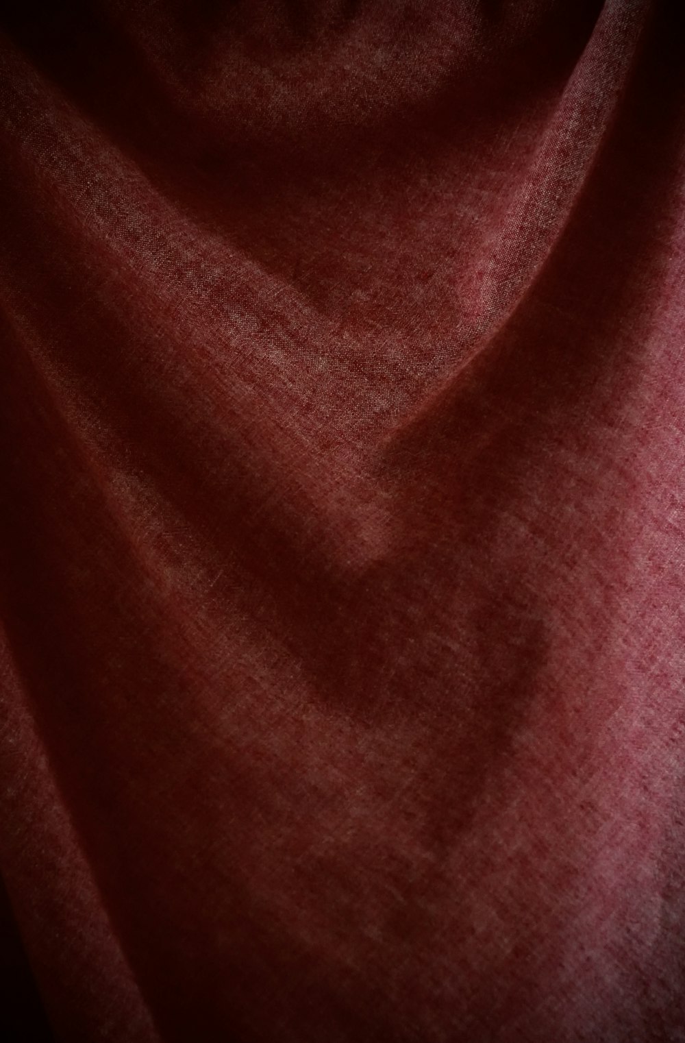 a close up of a red cloth with a black background