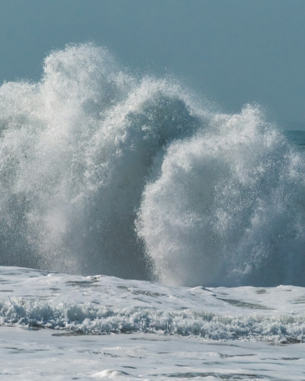 a man riding a wave on top of a surfboard