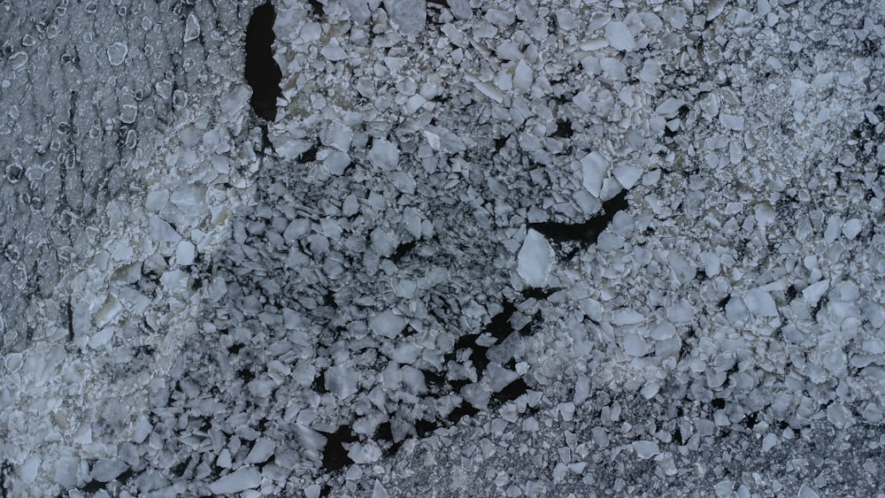 a black and white photo of snow and rocks