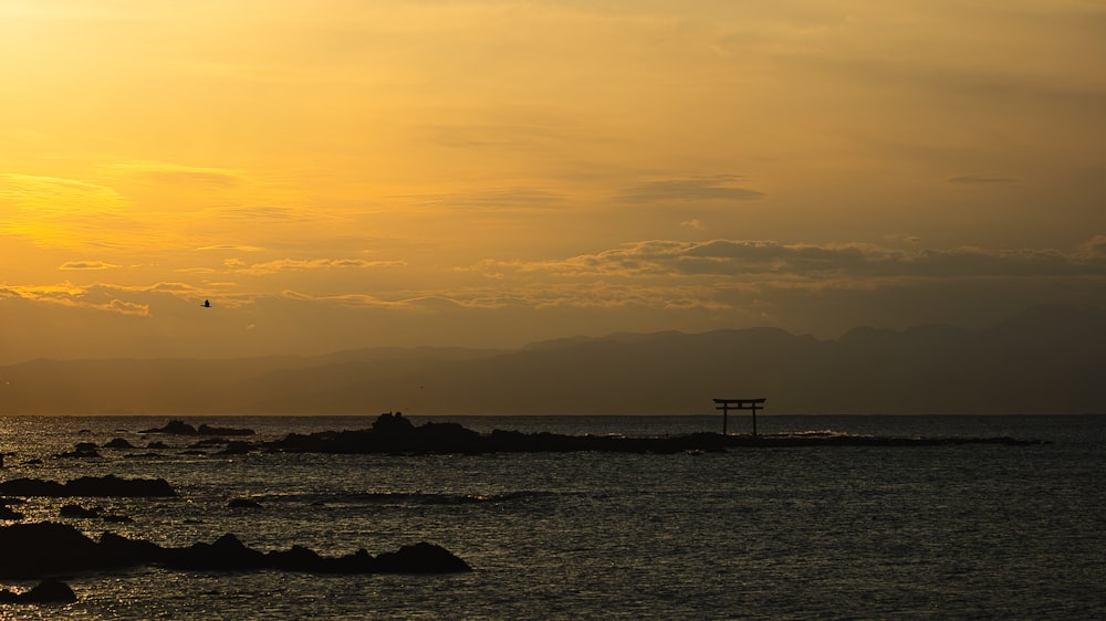 the sun is setting over a body of water