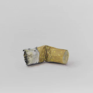 Close-up of a hand crushing a cigarette pack, symbolizing quitting smoking.