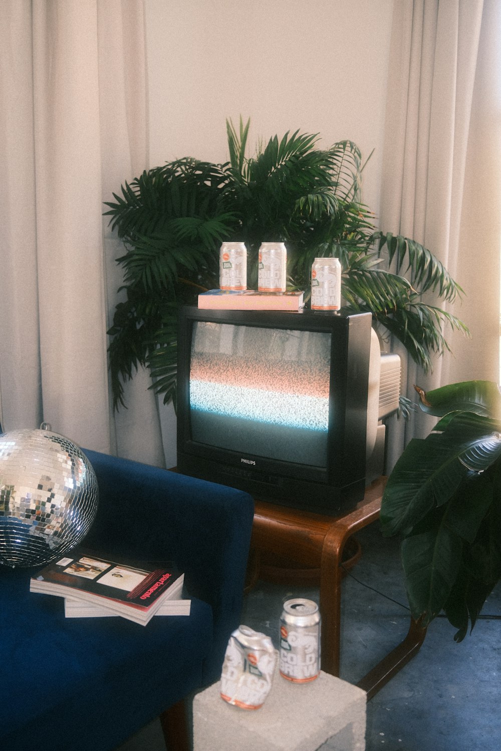 a living room with a blue couch and a television