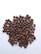A pile of roasted coffee beans spread out over a white surface, showcasing various shades of brown and some showing visible craters and cracks.