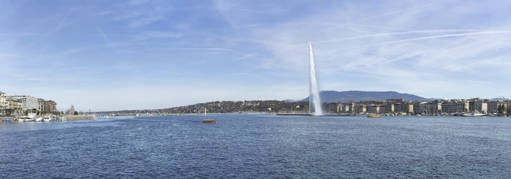 a large body of water with a tall tower in the background