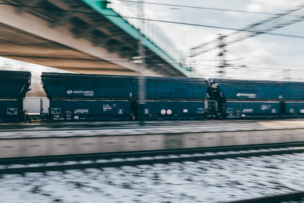 a man standing on a train track next to a bridge