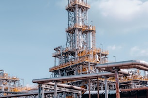 a factory with pipes and a sky background