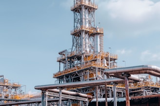 a factory with pipes and a sky background