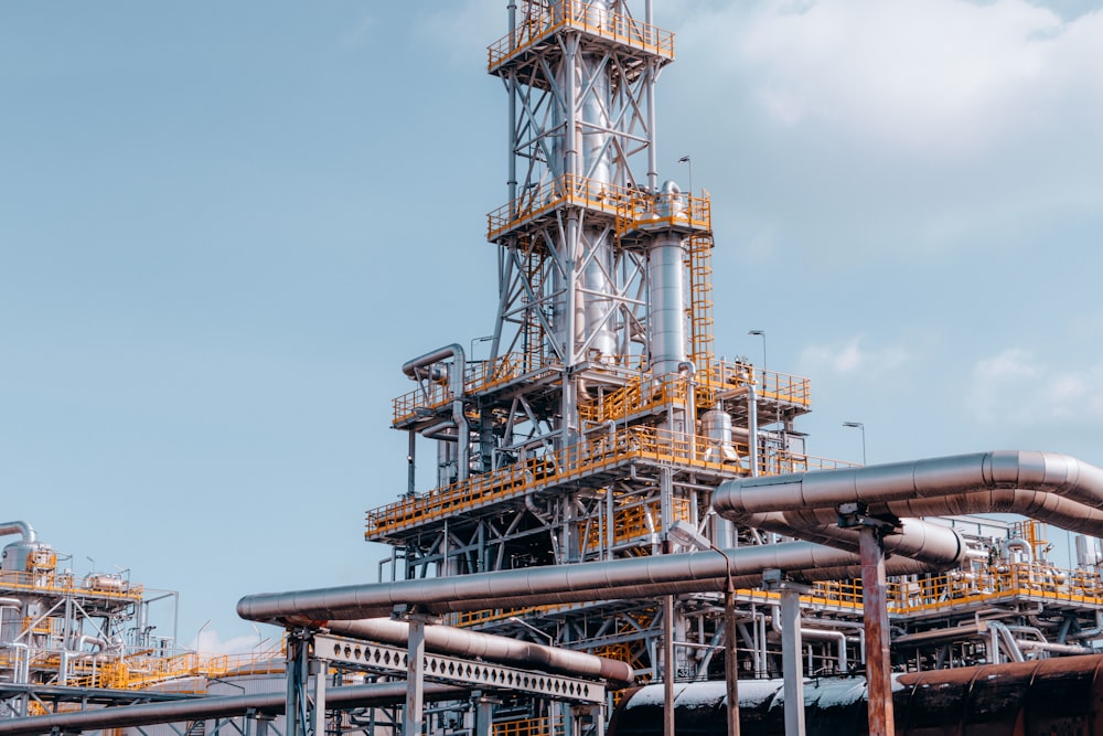 a factory with pipes and a sky background