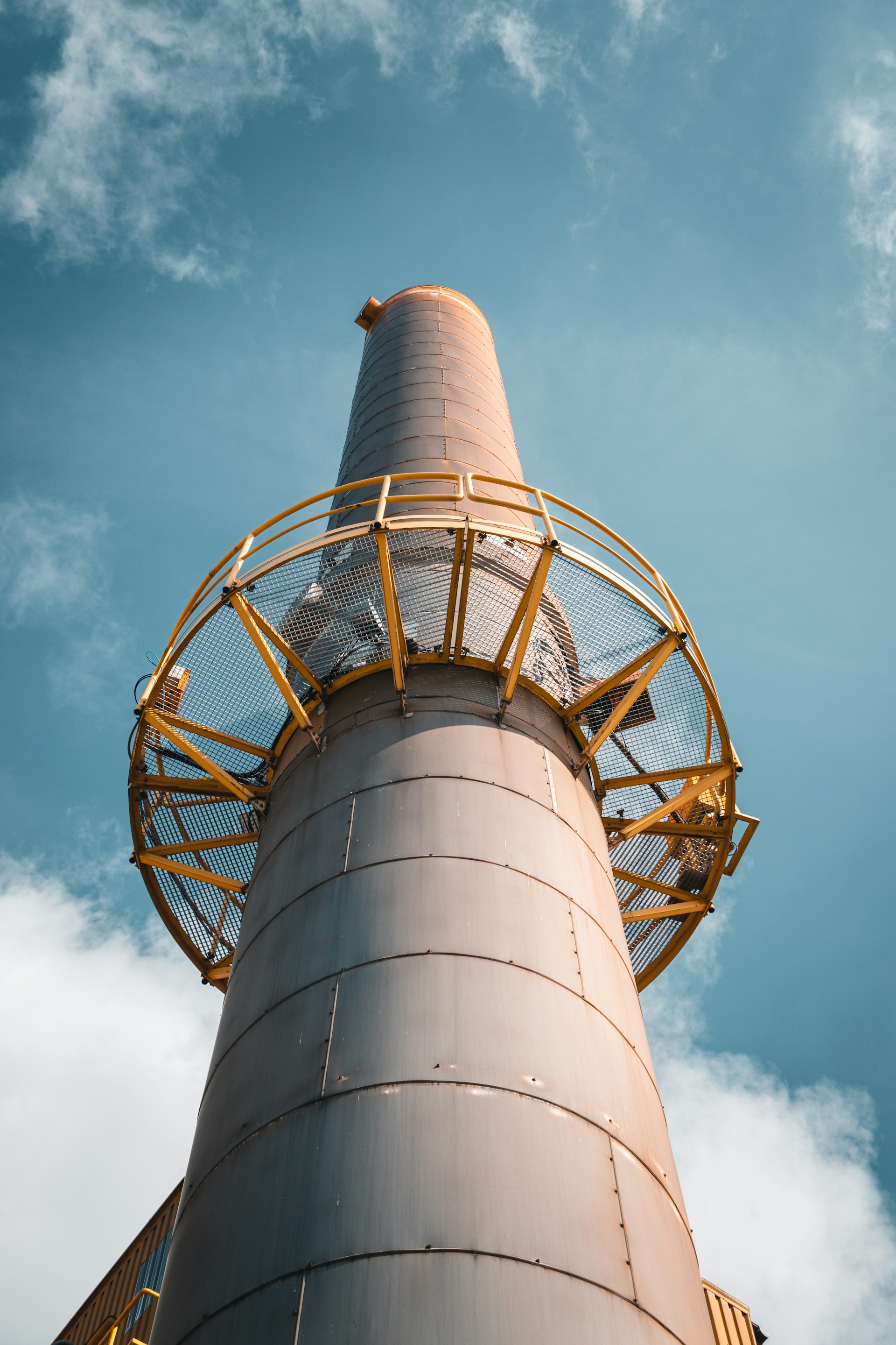 a tall metal tower with a sky background
