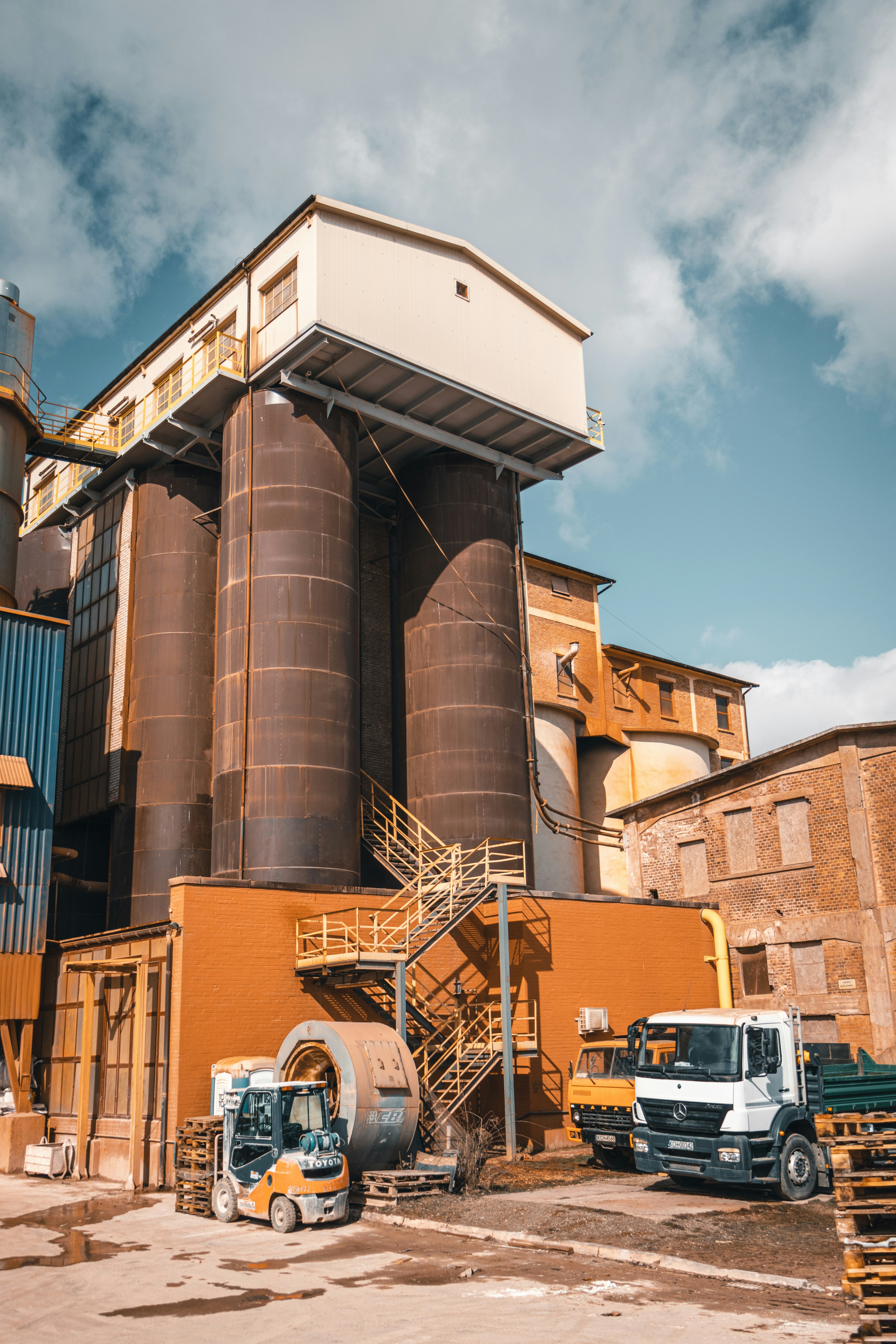 a large brown building with a truck parked in front of it