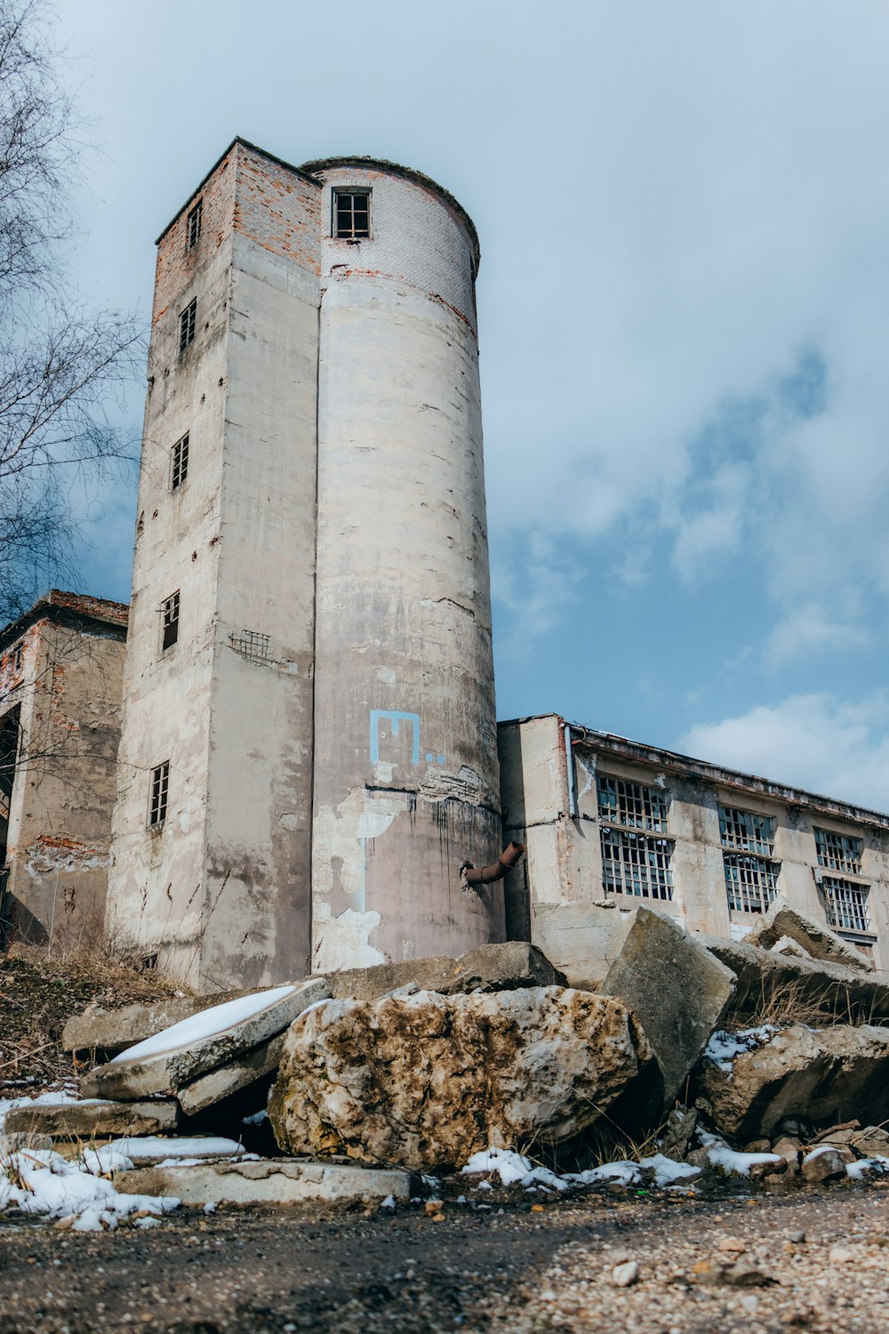 an old building with a large rock in front of it