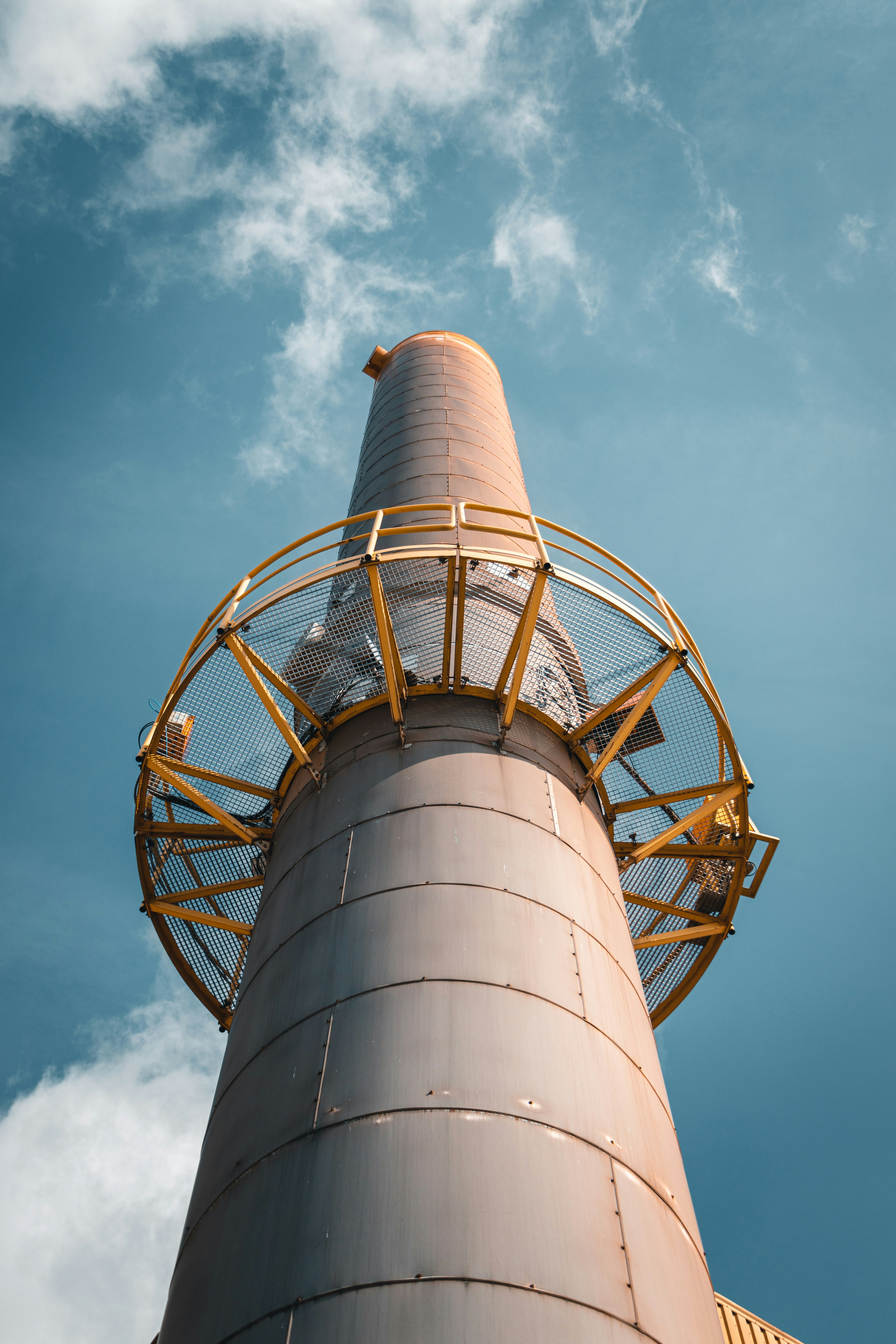 a tall metal tower with a sky background
