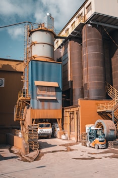 a factory building with a truck parked in front of it
