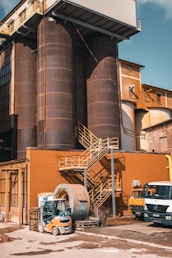 a large industrial building with a truck parked in front of it