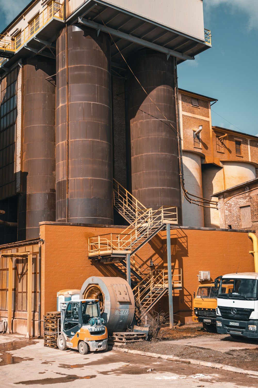 a large industrial building with a truck parked in front of it