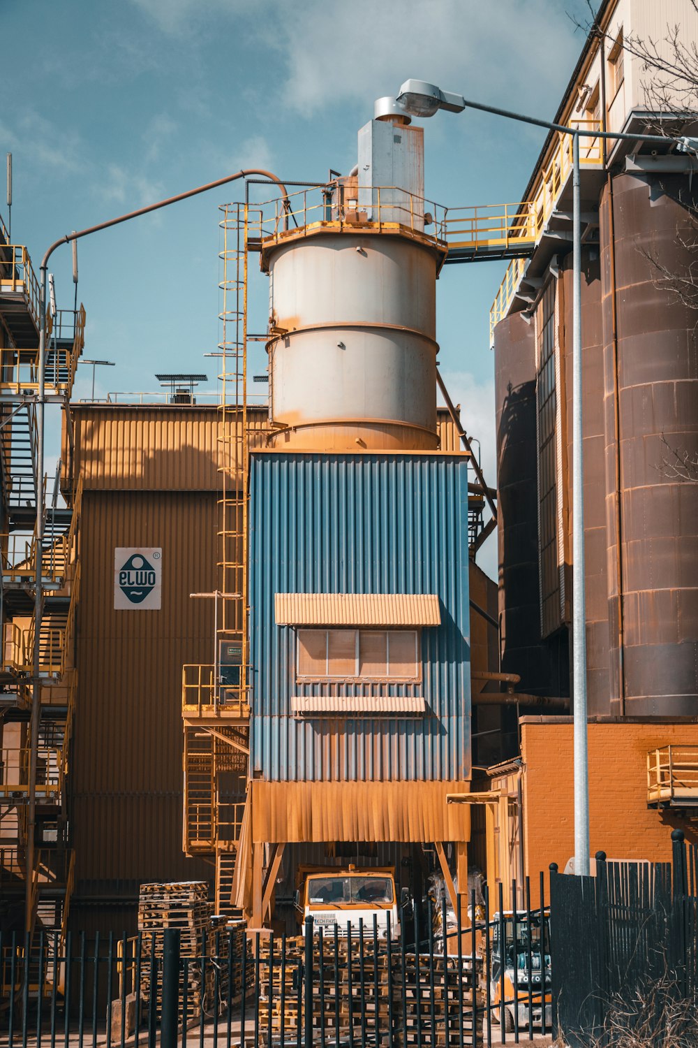 a factory building with a blue and brown building next to it