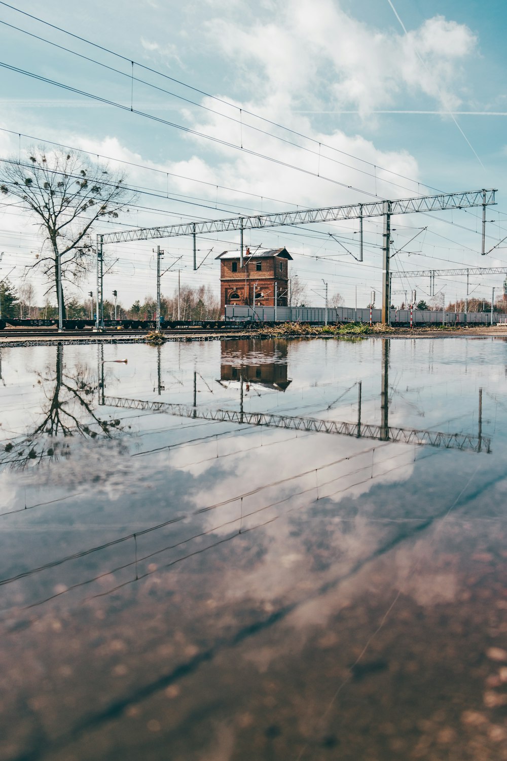 a flooded area with power lines and a building in the background