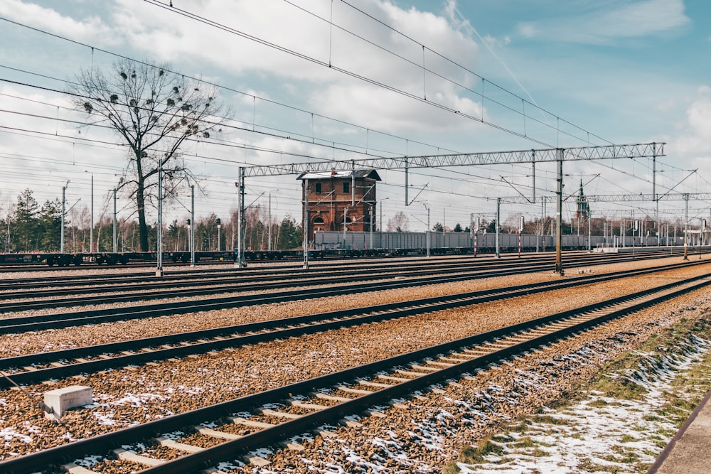 a train track with lots of power lines above it