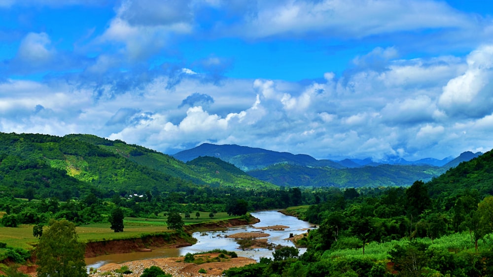 a river running through a lush green valley