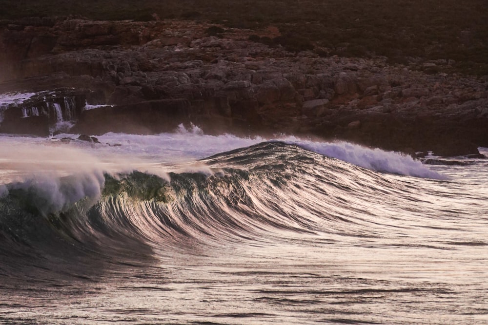 a large wave is coming towards the shore