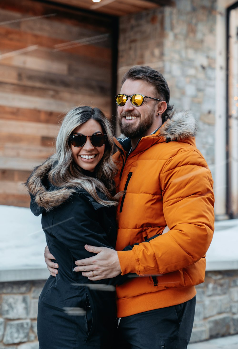 a man and a woman standing together in front of a building