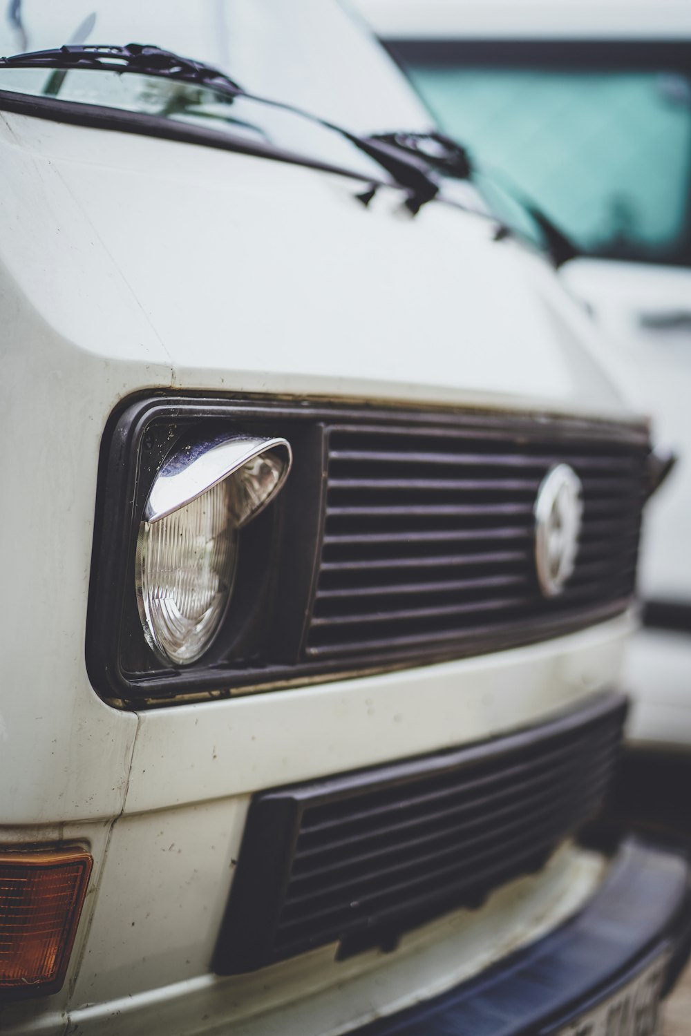 a close up of the front of a white car