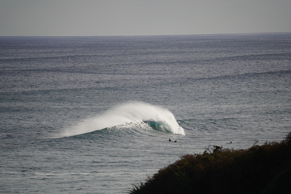 a person riding a wave on top of a surfboard