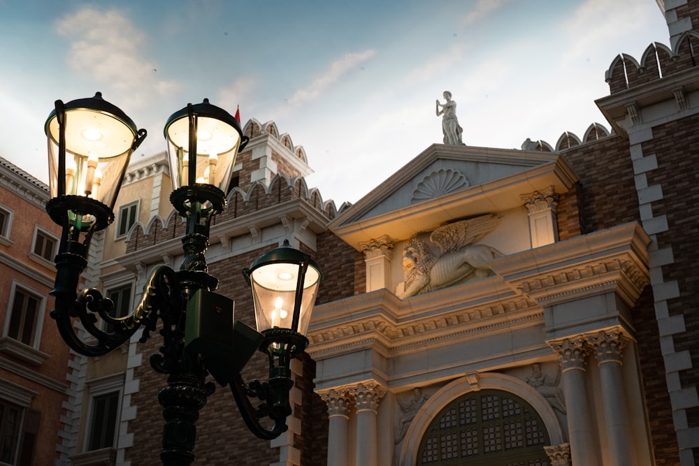 a couple of street lights in front of a building