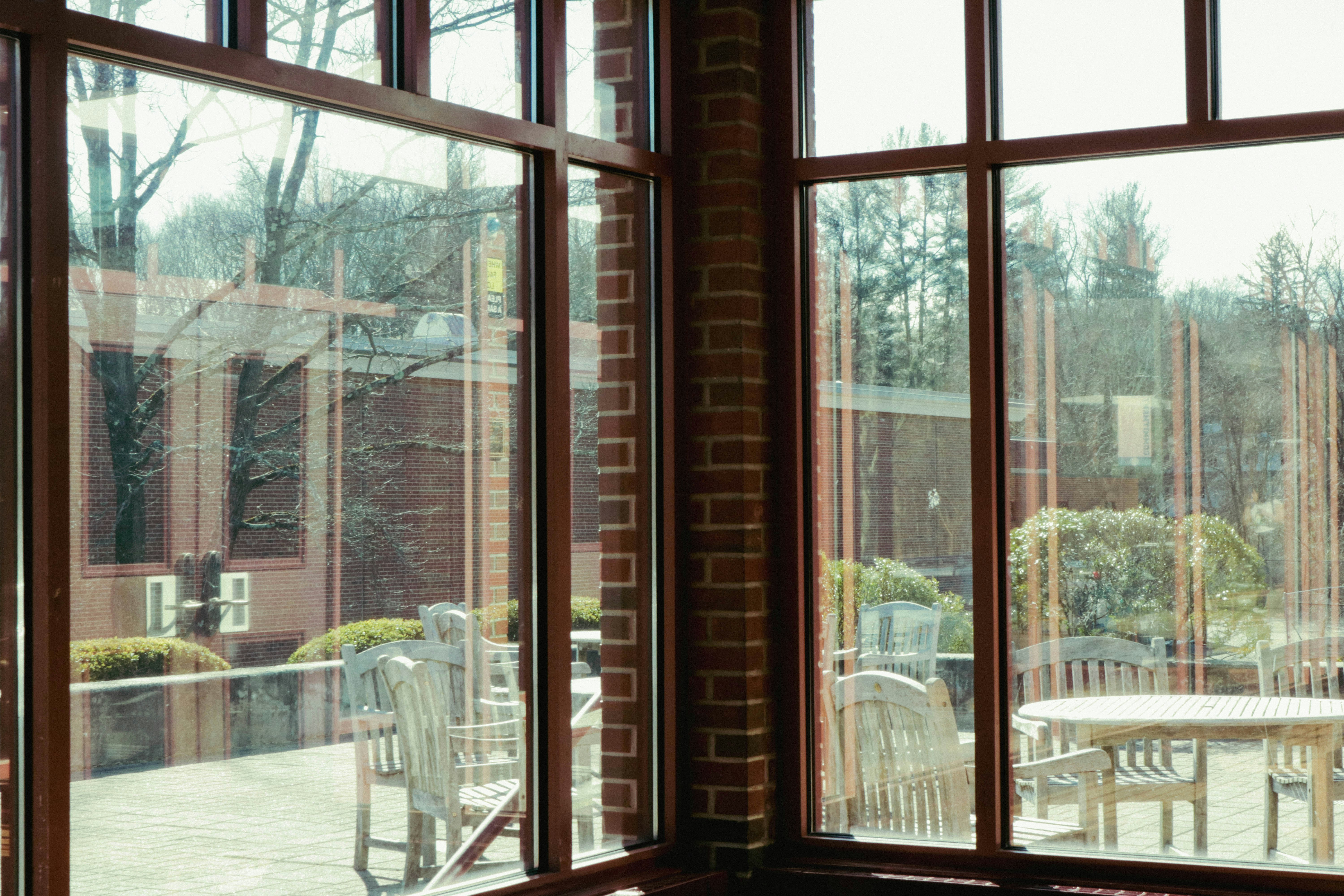 a room with a table, chairs, and a large window