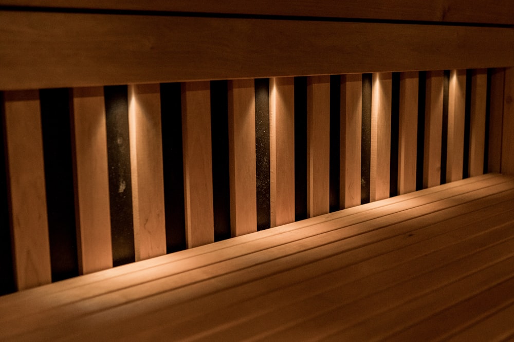 a close up of a wooden bench with lights