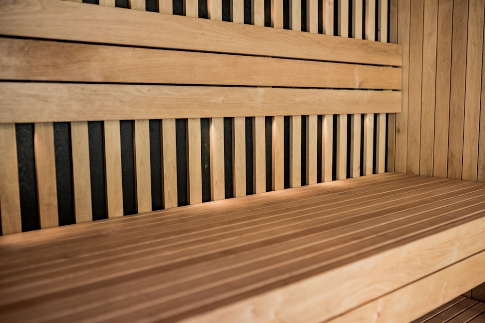 a close up of a wooden bench with horizontal slats
