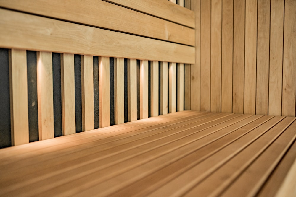 a close up of a wooden bench with slats