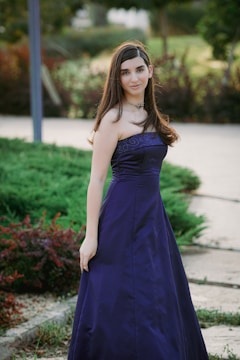 a woman in a blue dress posing for a picture