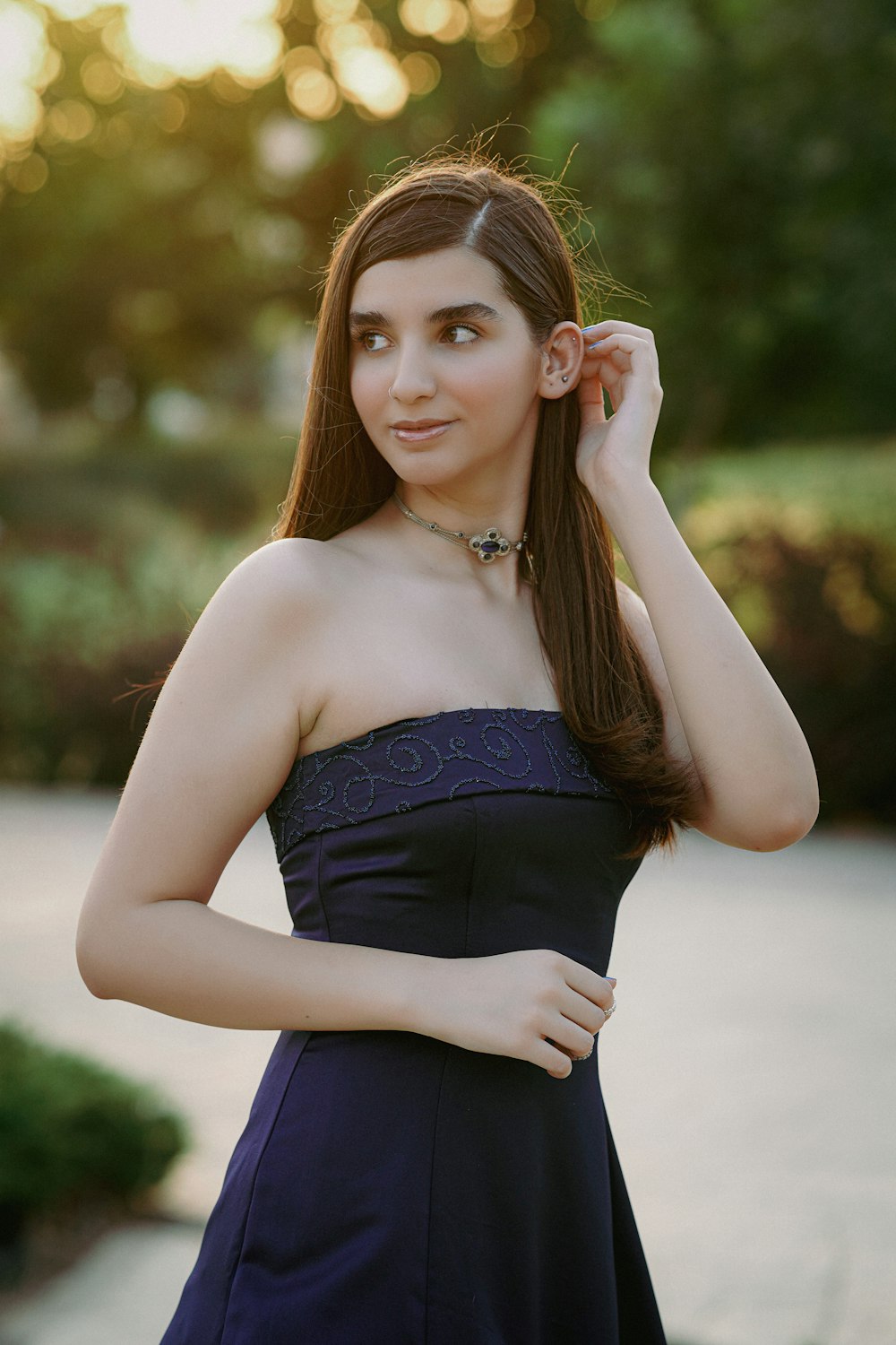 A woman in a strapless dress poses for a picture photo – Free Dress Image  on Unsplash