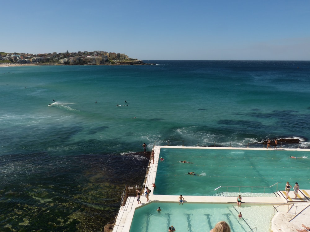 a large swimming pool with people swimming in it