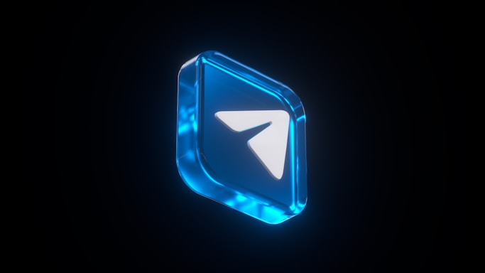 A 3D blue icon with a white paper plane symbol at the center, surrounded by a translucent blue border, positioned against a dark background.