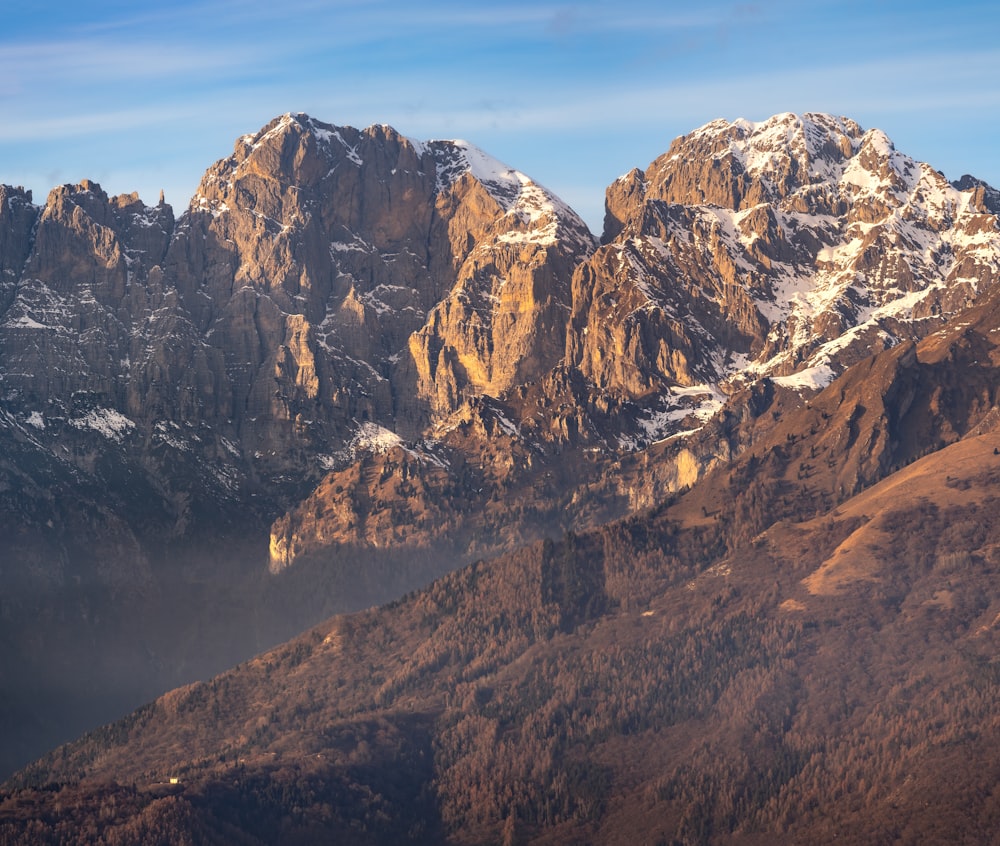 a view of a mountain range with snow on it