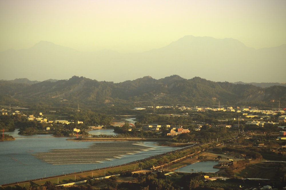 an aerial view of a city with mountains in the background