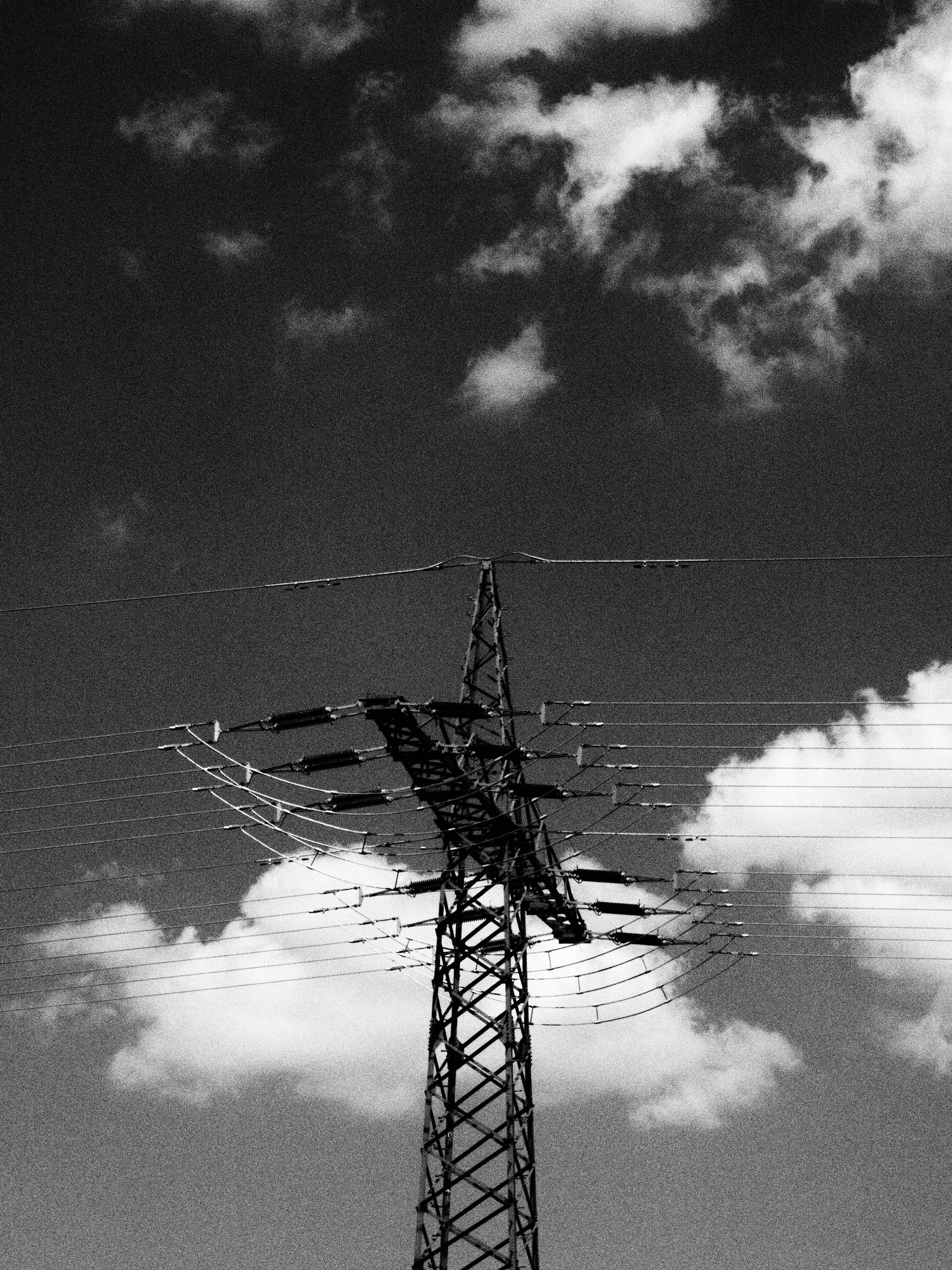 a tall tower with lots of power lines on top of it