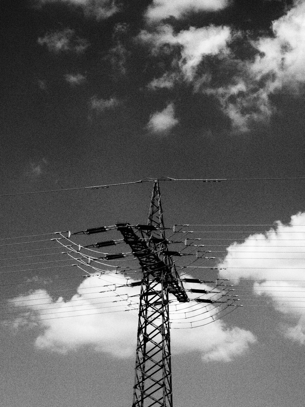 a tall tower with lots of power lines on top of it